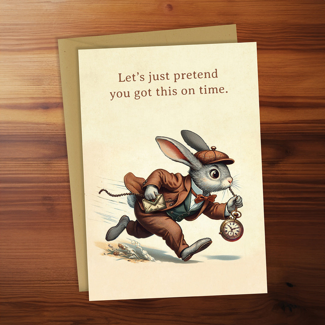 Greeting card with a rabbit illustration and humorous text on a wooden surface