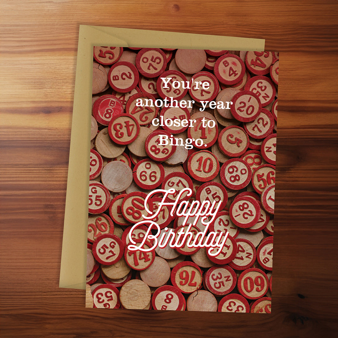 Birthday card with bingo chips design on a wooden surface