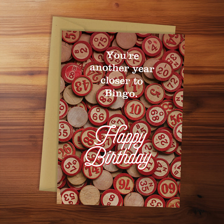 Birthday card with bingo chips design on a wooden surface