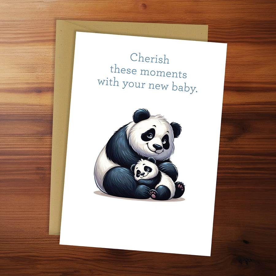 Greeting card with panda illustration and text on a wooden surface