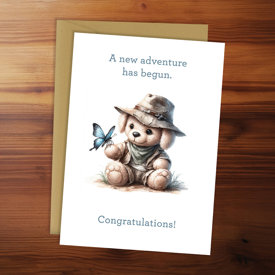 Greeting card with teddy bear and butterfly illustration on a wooden surface