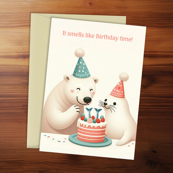 Birthday card with polar bears and a cake on a wooden surface