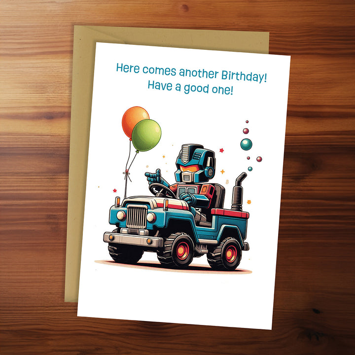 Birthday card with a robot in a truck and balloons on a wooden surface