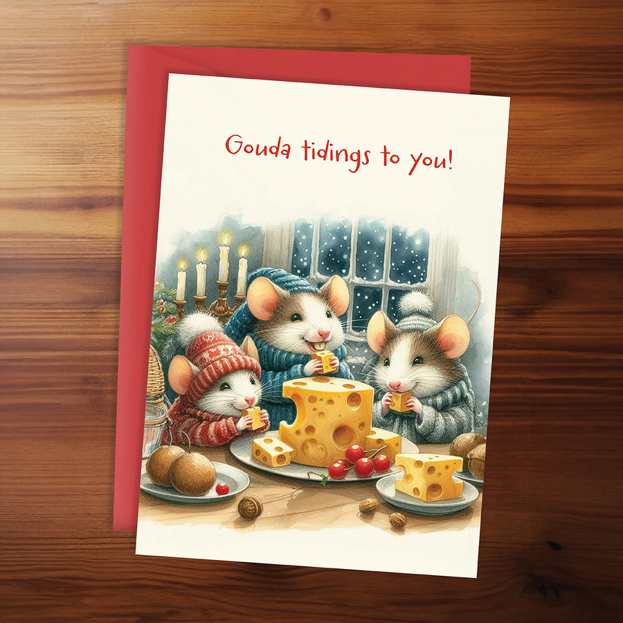 Greeting card with illustration of mice around a cheese wheel on a wooden surface
