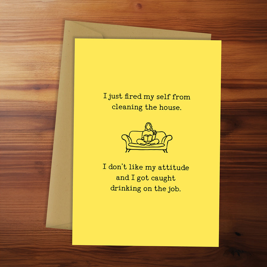 Yellow card with humorous text and illustration on a wooden surface