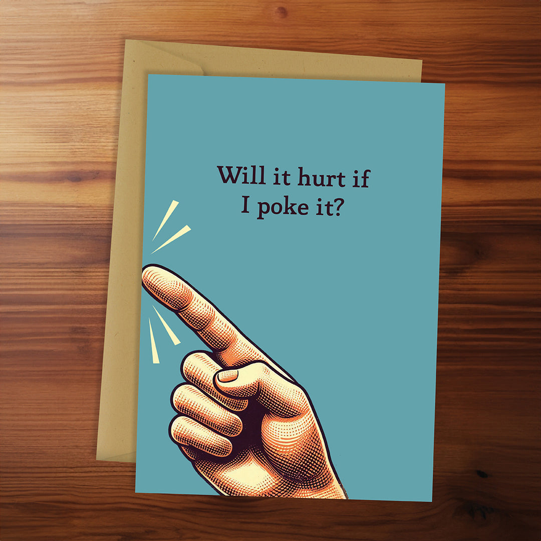 Card with a hand pointing and text 'Will it hurt if I poke it?' on a wooden surface