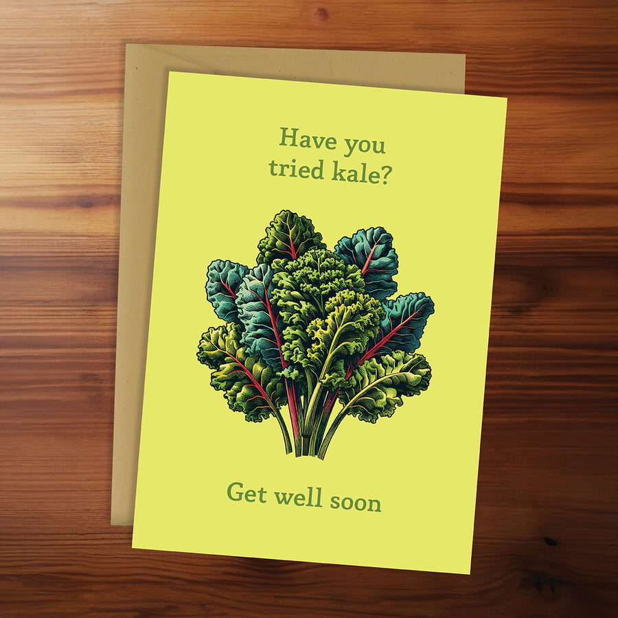 Greeting card with kale illustration and text on a wooden surface