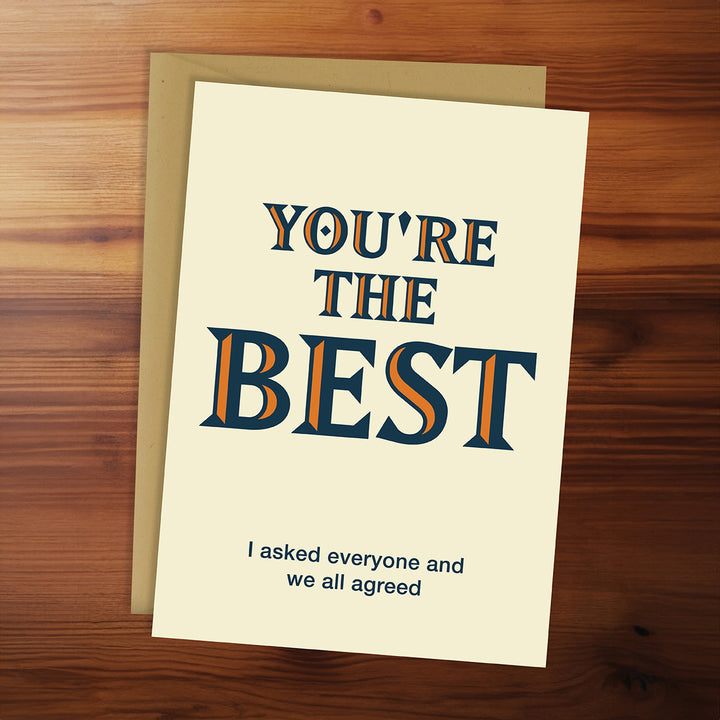 Card with 'You're the Best' text on a wooden surface