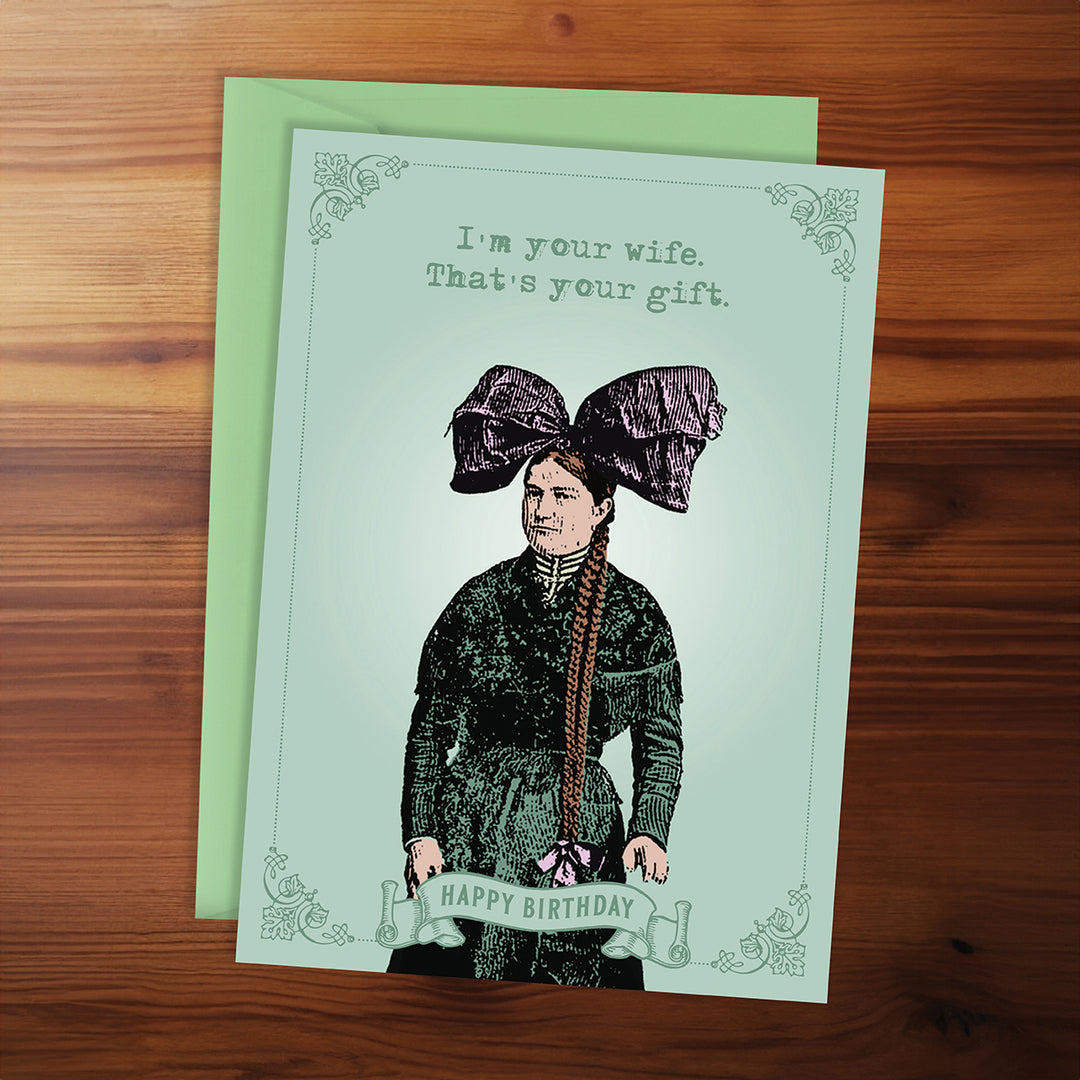 Greeting card with illustration of a woman and text on a wooden surface