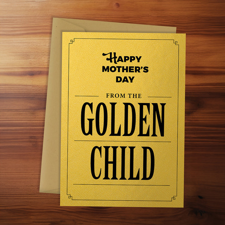 Greeting card with 'Happy Mother's Day from the Golden Child' text on a wooden surface