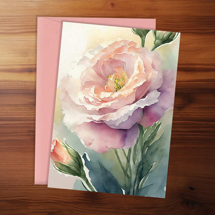 Floral card with a pink rose on a wooden surface