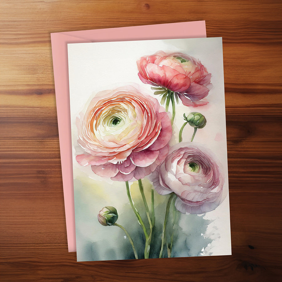 Greeting card with pink flowers on a wooden surface