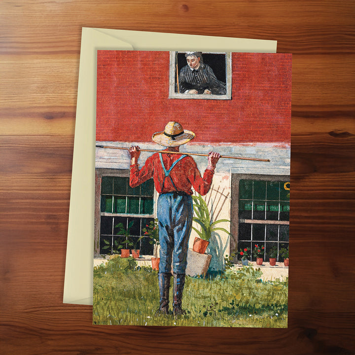 Greeting card with a farmer and barn scene on a wooden surface