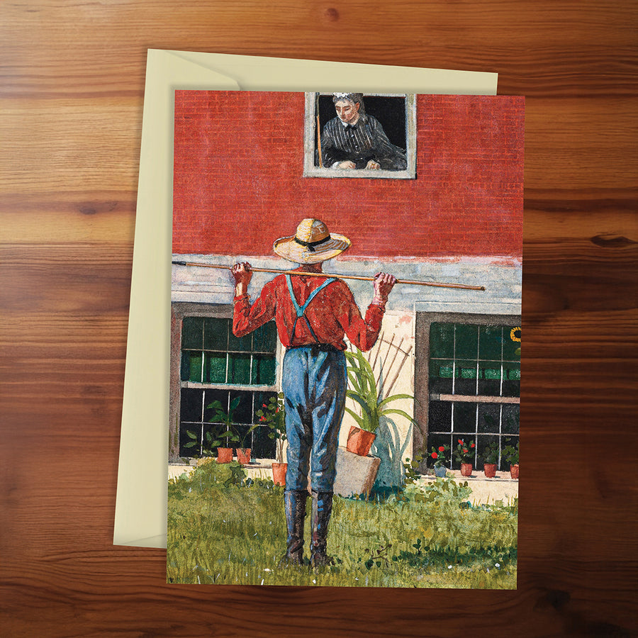 Greeting card with a farmer and barn scene on a wooden surface