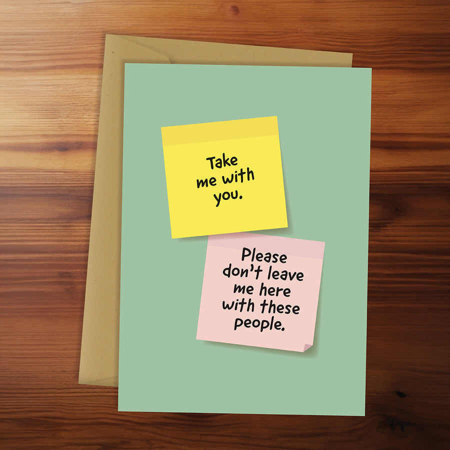 Green card with yellow and pink sticky notes on a wooden surface