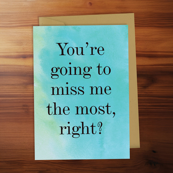 Greeting card with text 'You're going to miss me the most, right?' on a wooden surface