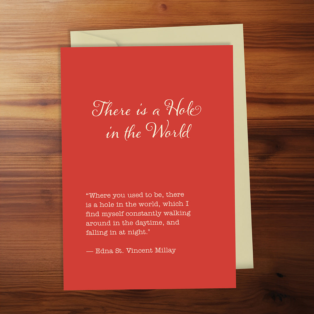 Red card with a quote on a wooden surface