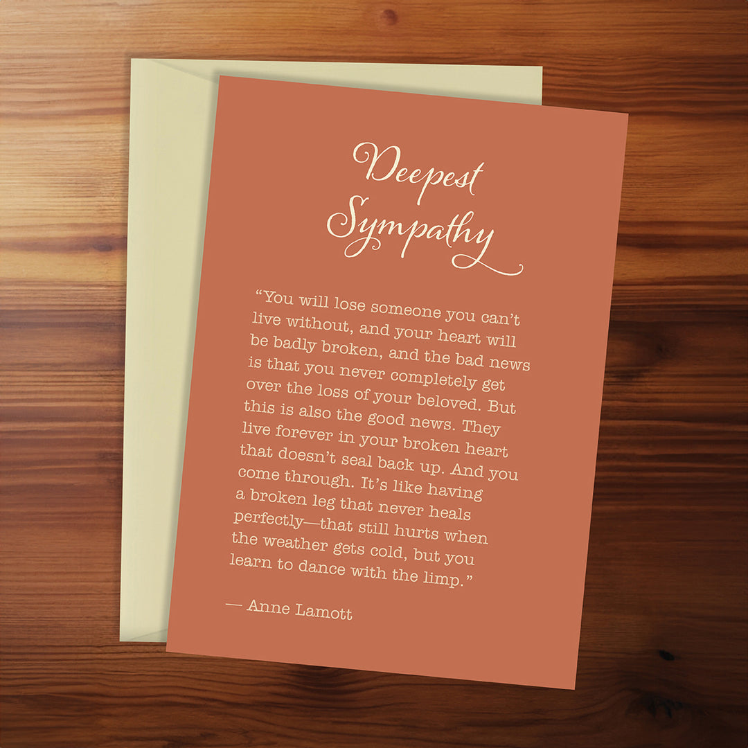 Card with 'Deepest Sympathy' message on a wooden surface