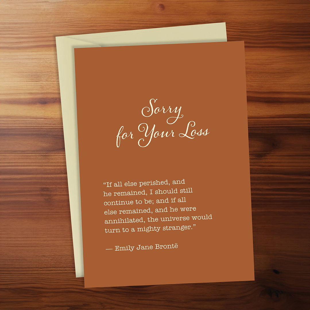 Brown card with 'Sorry for Your Loss' message on a wooden surface