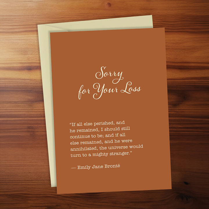 Brown card with 'Sorry for Your Loss' message on a wooden surface