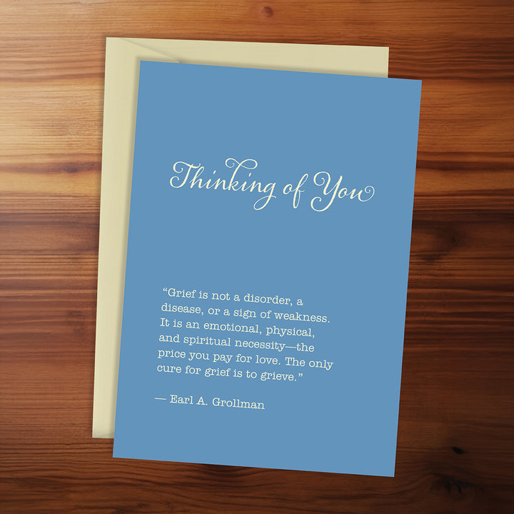 Blue card with text on a wooden surface