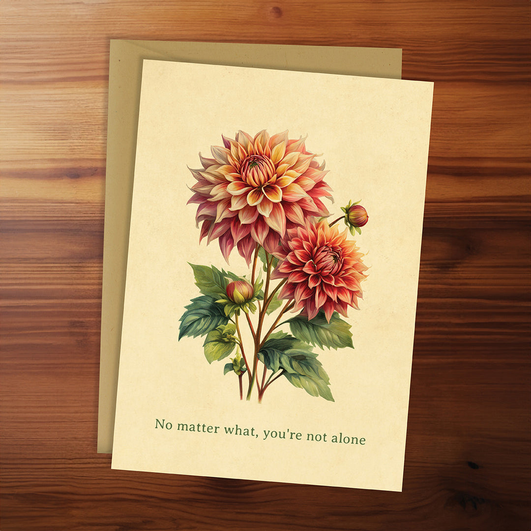 Greeting card with floral design and motivational quote on a wooden surface