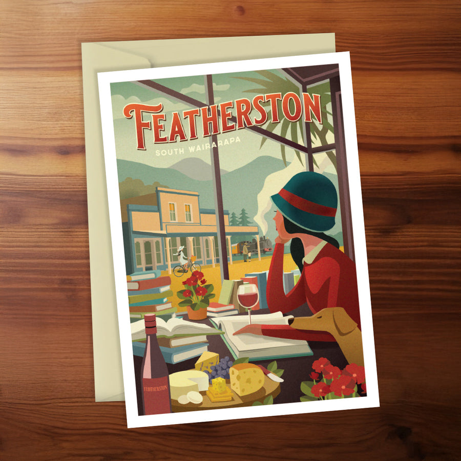 Greeting card with 'Featherston' design on a wooden surface