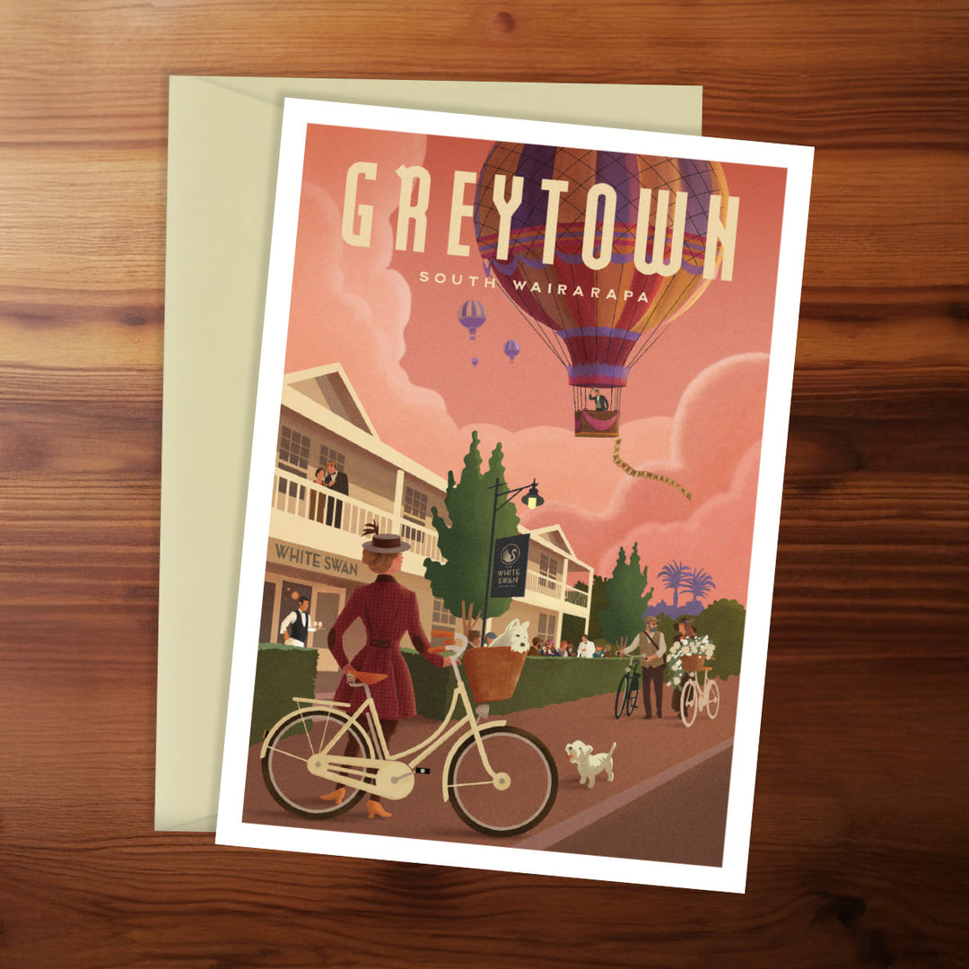 Poster of Greytown with a hot air balloon and people on a wooden surface